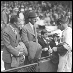 William Clay Ford receives a baseball from Detroit Tigers catcher Mickey Cochrane at a 19 September 1934 game against the New York Yankees. Also pictured are Edsel Ford (left) and Henry Ford. Only one is in the Hall of Fame.