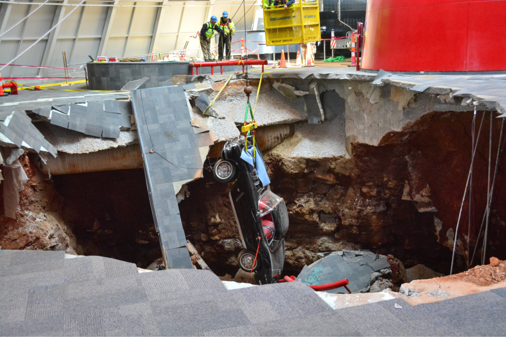 A crane is used to remove the black 1962 Chevrolet Corvette from the sinkhole at the National Corvette Museum on Tuesday 4 March 2014 in Bowling Green, Kentucky. 