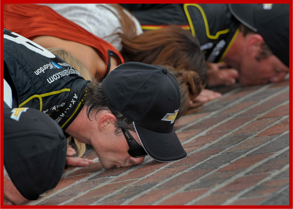 Jeff Gordon, driver of the #24 Axalta Chevrolet SS, kisses the Brick after his win Sunday 27 July 2014 of the Brickyard 400 Nascar Sprint Cup race at Indianapolis Motor Speedway. Gordon leads the NASCAR Sprint Cup Series standings, and has won at the Brickyard a record 5 times, the first one in 1994.